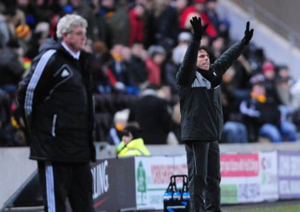 Watford manager Gianfranco Zola (right) and Hull City manager Steve Bruce on the touchline during the npower Football League Championship match at the KC Stadium, Hull. (Picture: Anna Gowthorpe/PA Wire).