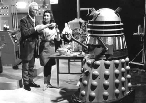 Peter Cushing gets up close and personal with the Daleks in Dr Who.
