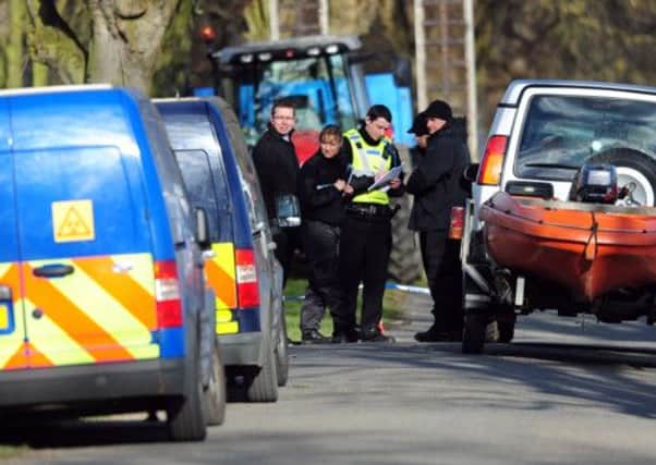 Police at the scene where two bodies were found near Peterborough