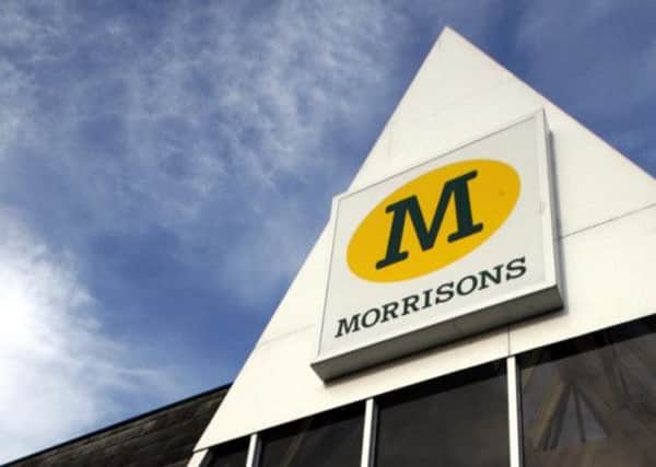Nearly 700 jobs are at risk at Morrisons as the supermarket cuts costs after a fall in annual profits.
