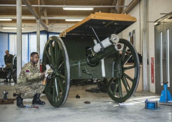 Lance Bombardier Nikopaul Powell cleaning the Ceremonial Gun Carriage