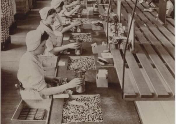 Ladies packing Smarties in the Rowntree factory in York.  Photo:  Societe des Produits Nestle S.A. Below: Neil Hanson and Lynn Russell.