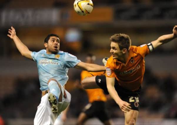 Wolverhampton Wanderers' Kevin Doyle (right) and Hull City's Ahmed Fathi (left) battle for the ball.