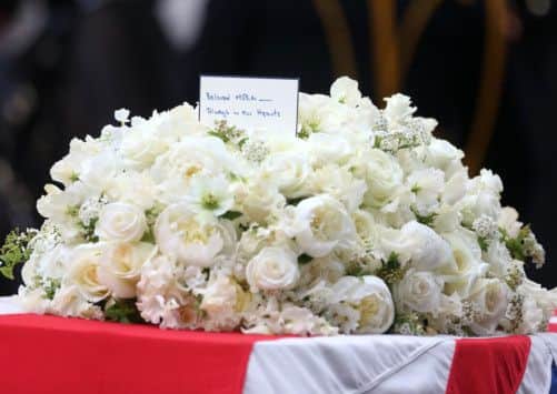 A bouquet of flowers sits atop of the  coffin of Baroness Thatcher as it arrives at St Paul's Cathedral