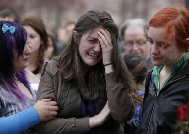 Emma MacDonald, 21, cries during a vigil for the victims of the Boston Marathon explosions at Boston Common