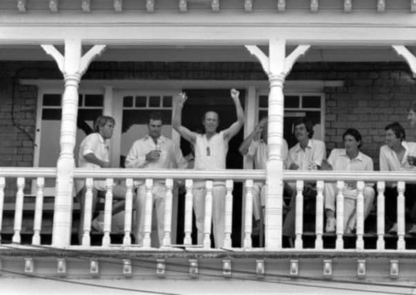 England's Geoff Boycott celebrates victory on the balcony at Trent Bridge with a glass of champagne