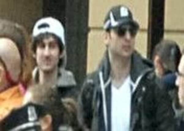 This photo released by the FBI early Friday April 19, 2013, shows what the FBI is calling the suspects together,  walking through the crowd in Boston on Monday, April 15, 2013, before the explosions at the Boston Marathon.