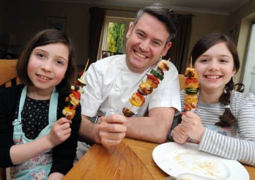 Colin McGurran with Millie and Hannah Scott with their kebabs ready to eat