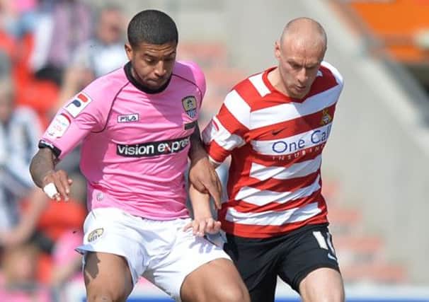 Notts County's Joss Labadie battles with Doncaster Rovers' David Cotterill