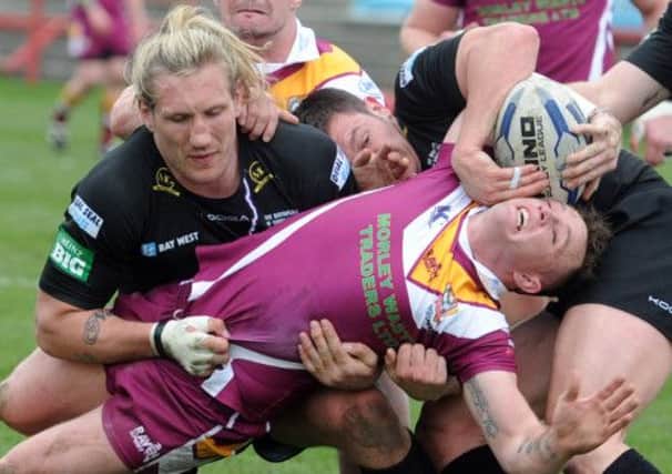 Giants Eorl Crabtree and Brett Ferres stop Bulldogs George Flanagan grounding the ball