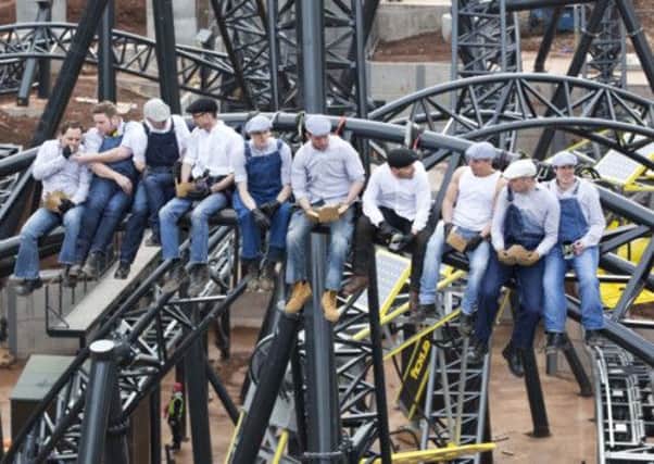 Workmen from Alton Towers Resort in Staffordshire, celebrated the completion of the new worlds-first highest roller coaster, The Smiler, by creating a modern-day version of the famous Lunch atop a Skyscraper shot from 1932.