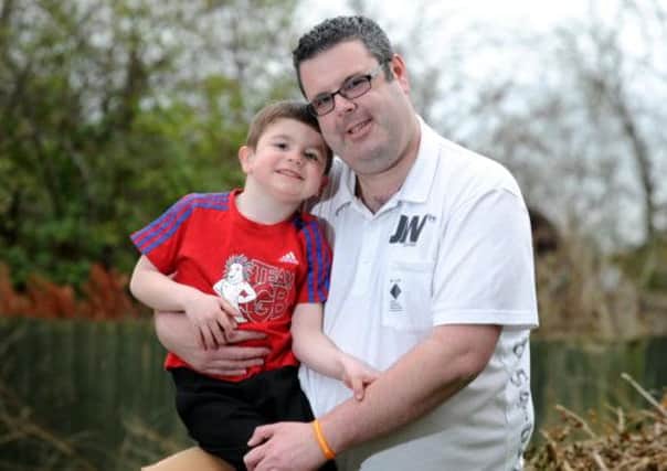 Mark Creswick with his son Harley, 5, at home in High Green, Sheffield. Picture By Simon Hulme