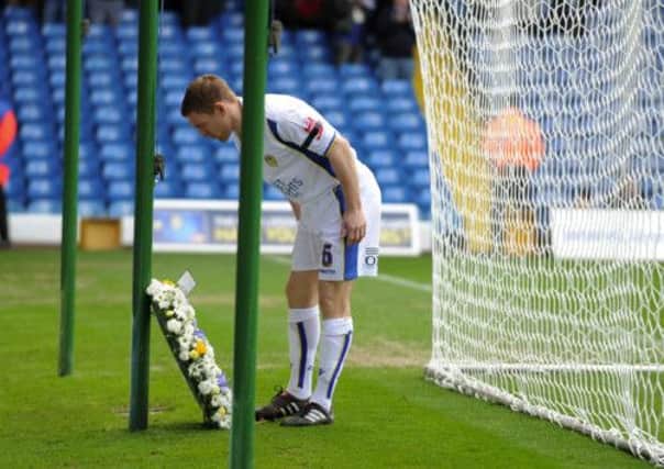 Then-Leeds captain Richard Naylor lays a wreath  for victims Kevin Speight and Christopher Loftus in 2010
