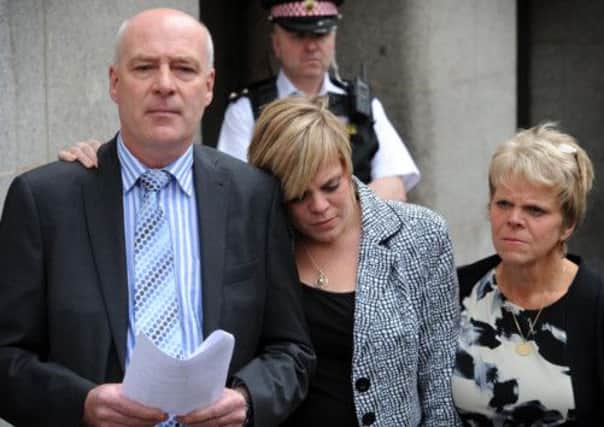 Bob and Sally Dowler, parents of murdered school girl Milly Dowler and her sister Gemma (centre).