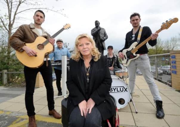 Don Revie's daughter Kim is pictured with the band Rubylux, outside the Don Revie Statue, Elland Road.