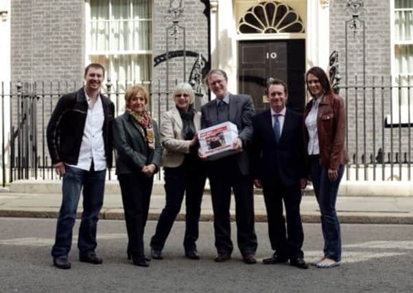 Bookshop couple Frances and Keith Smith (centre) with Margaret Hodge MP (2nd left), Chris White MP (2nd right), and the couple's son David Smith and daughter-in-law Jennifer Strejevitch outside 10 Downing Street,