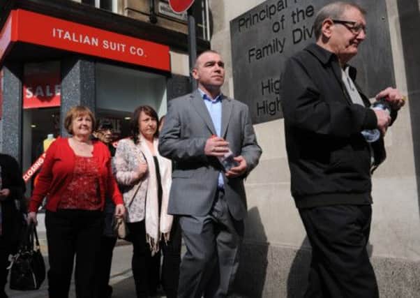 Families of Hillsborough victims arrive at a preliminary hearing in London today into the deaths of the 96 people killed in the disaster of 1989.