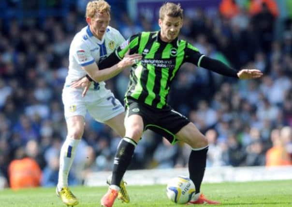Leeds's Paul Green gets to grips with Brighton's Andrea Orlandi.
