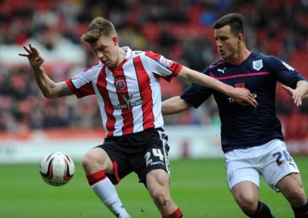 Sheffield United's Joe Ironside, secures the ball in front of Preston North End's Bailey Wright.