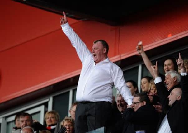 Rotherham Utd's  manager Steve Evans celebrates in the stand as his team are promoted during the npower League Two match at the New York Stadium, Rotherham.