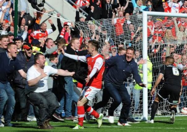 Rotherham United's Lee Frecklington celebrates scoring their second goal as the fans invade the pitch