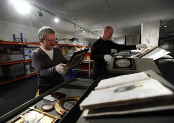 Greg Hobson, Curator of Photographs, with some early images from the collection and Brian Liddy, Collections Access Manager at the National Media Museum, browses through one of Francis Frith's collection of photographs housed in museum's archive. Below: Wood Exchange in Bradford taken nearly 150 years ago.