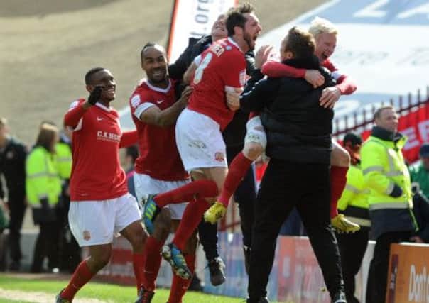 Barnsley players celebrate Chris O'Gradys goal with their manager and staff