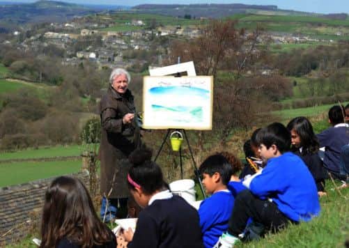 Artist Ashley Jackson gives inspiration to school pupils from London, on the hills above Holmfirth.