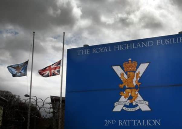 Flags at fly half mast at Glencorse Barracks, the home of the Royal Highland Fusiliers, near Edinburgh