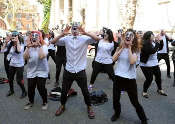 Protestors with their faces painted as badgers protest against badger culling outside Defra, London.