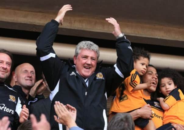 Hull City's manager Steve Bruce celebrates in the stands