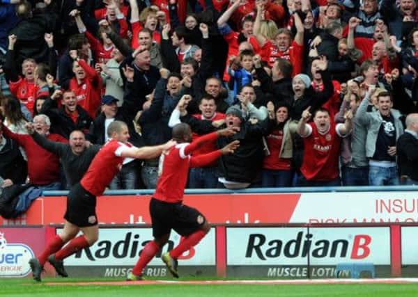 Jason Scotland celebrates his goal with the Barnsley fans.
