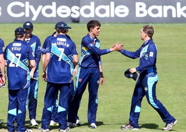 Yorkshire's Will Rhodes (second right) is congratulated by Gary Ballance (right) on the wicket of Glamorgan's Jim Allenby. Picture: swpix.com