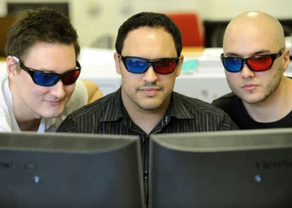 Adam Lay, Mo Akhtar and Ryan Blackburn  some of the team at  SoVibrant in Harrogate looking at some 3D images on screen through 3D glasses.