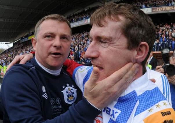 Huddersfield Town manager Mark Robins and owner Dean Hoyle celebrate after the final whistle.