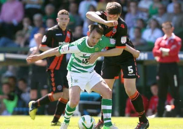 Yeovil Town's James Hayter (centre) and Sheffield United's Harry Maguire battle for the bal. (Picture: David Davies/PA Wire).