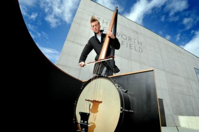 Musician Maxwell Sterling with the Octobass designed by his mother, artist Linder Sterling