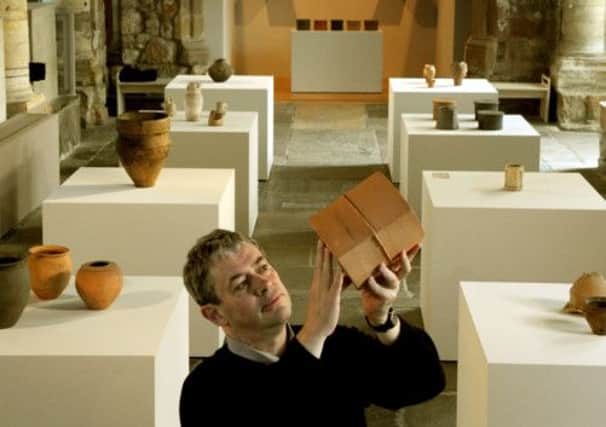 Artist Julian Stair holding one of his pots