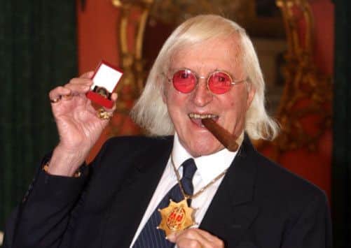 Jimmy Savile after he received a commemorative badge from Prime Minister Gordon Brown