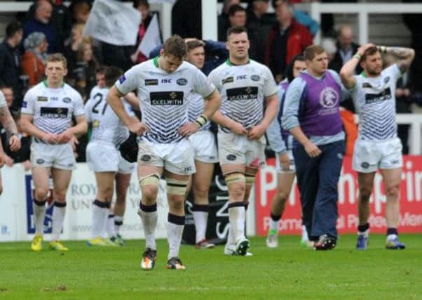 Jacob Rowen leads the dejected Leeds players off
