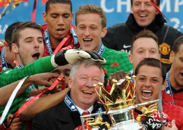 Manchester United manager Sir Alex Ferguson celebrates with the Barclays Premier League trophy