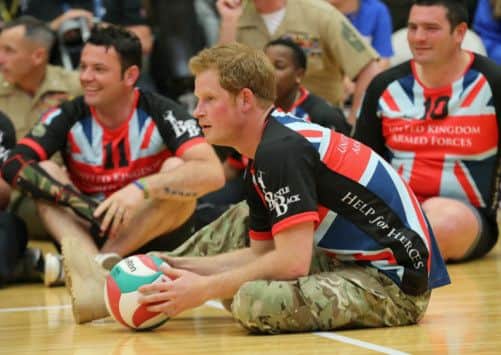 Prince Harry plays for the UK team against the USA during a seated volleyball exhibition match during the Warrior Games