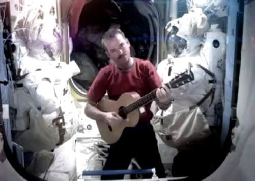 Commander Chris Hadfield has said goodbye to life on the International Space Station by making a cover version of David Bowie's Space Oddity.