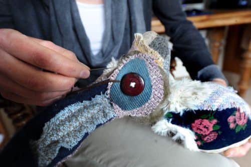 Former firefighter Leanne Owen makes stuffed animal heads out of fabric.
