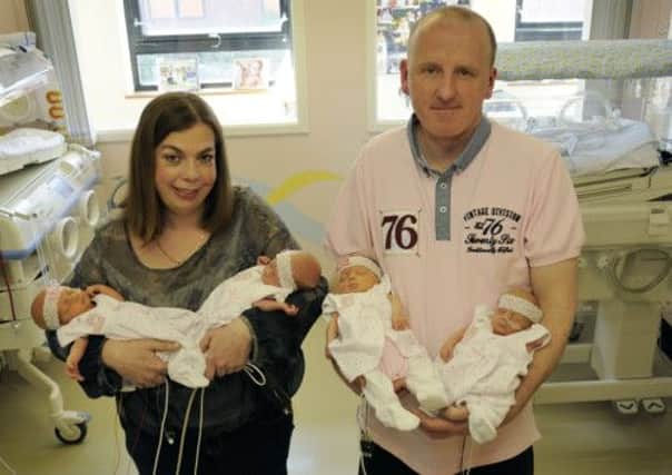 Parents Chris and Justin Clark with their quadruplets.