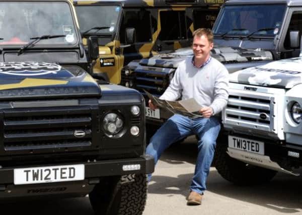 Charlie Fawcett, Managing Director of Twisted at Thirsk, with some of the landrover defenders taking part in the 2013 trans -European Gumball 3000 rally.