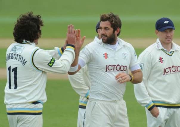 Yorkshire's Liam Plunkett (left) celebrates taking the wicket of Warwickshire's Tim Ambrose