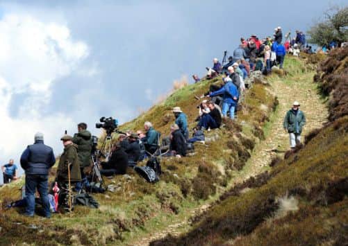 Spectators wait for the Battle of Britain Memorial Flight flypast over the Derwent Reservoir