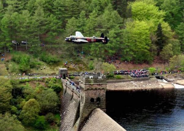 A Lancaster bomber during the Battle of Britain Memorial Flight performs a flypast over the Derwent Reservoir