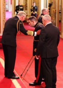 Lance Bombardier Benjamin Parkinson receiving his MBE from the Prince f Wales.